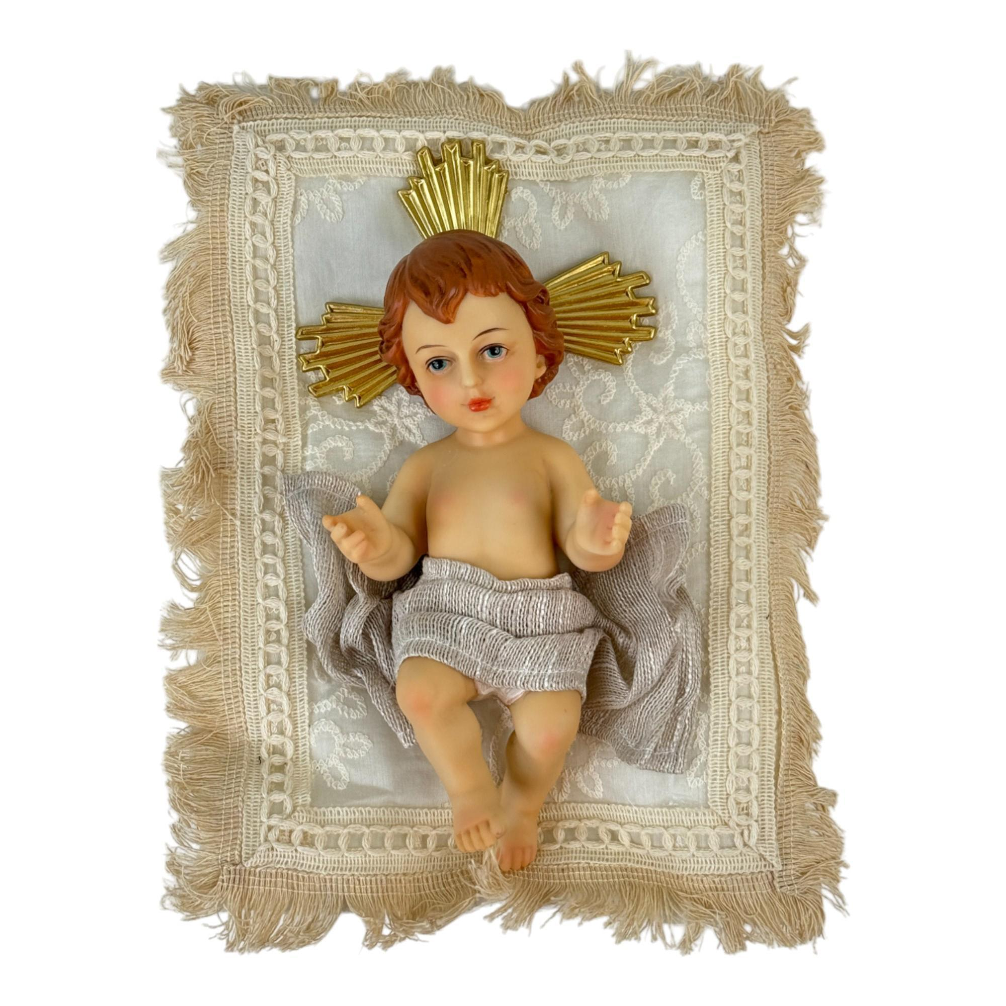 Figura Niño Jesús acostado sobre cojín
