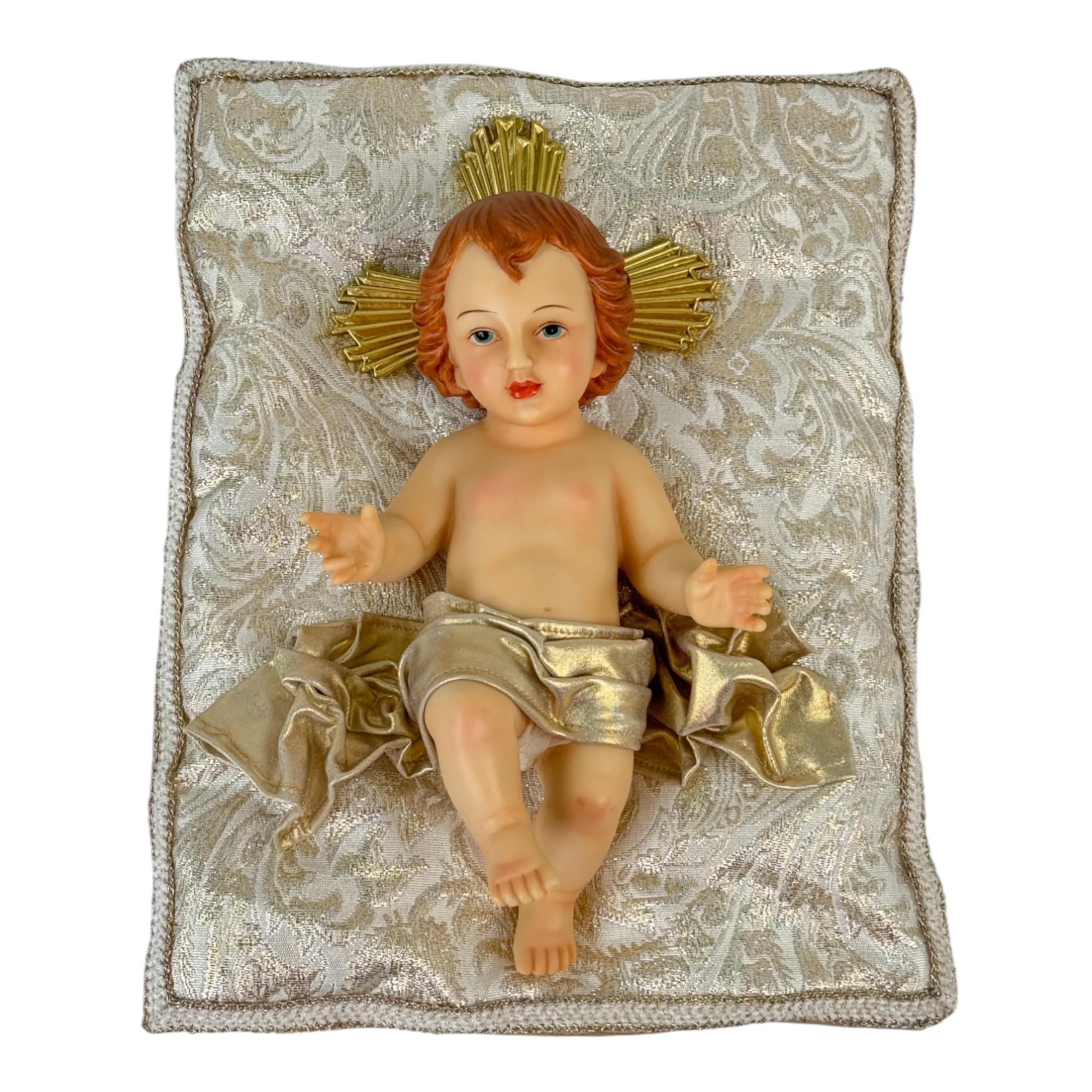 Figura Niño Jesús con túnica blanca sobre cojín